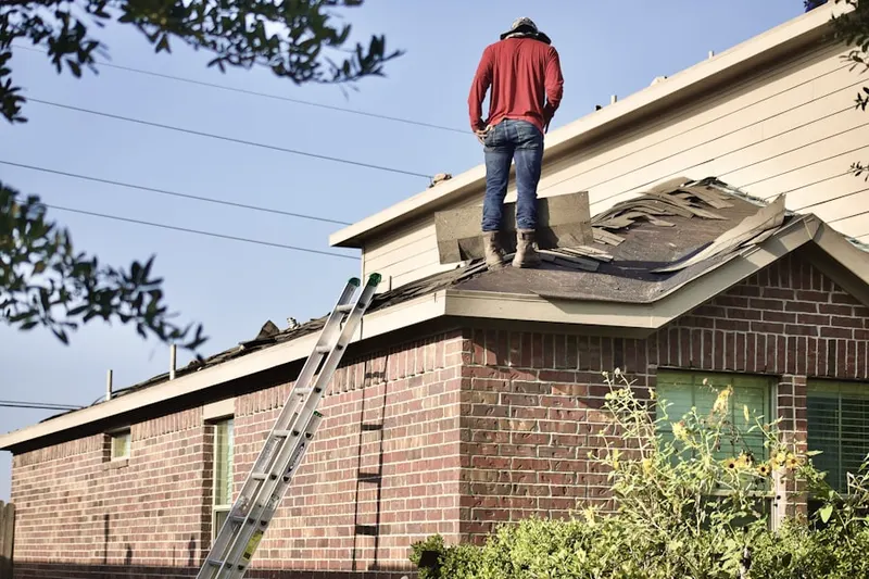 Professional roofer working on a residential roof in Shewville